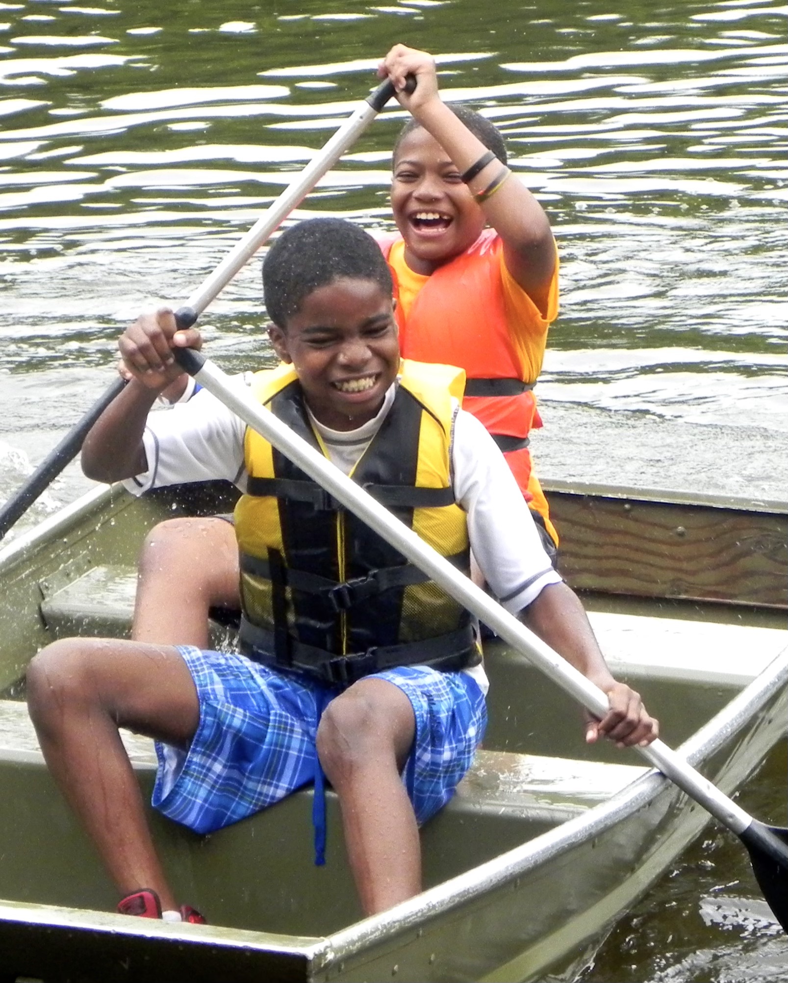 Two African American Scouts in a row boat